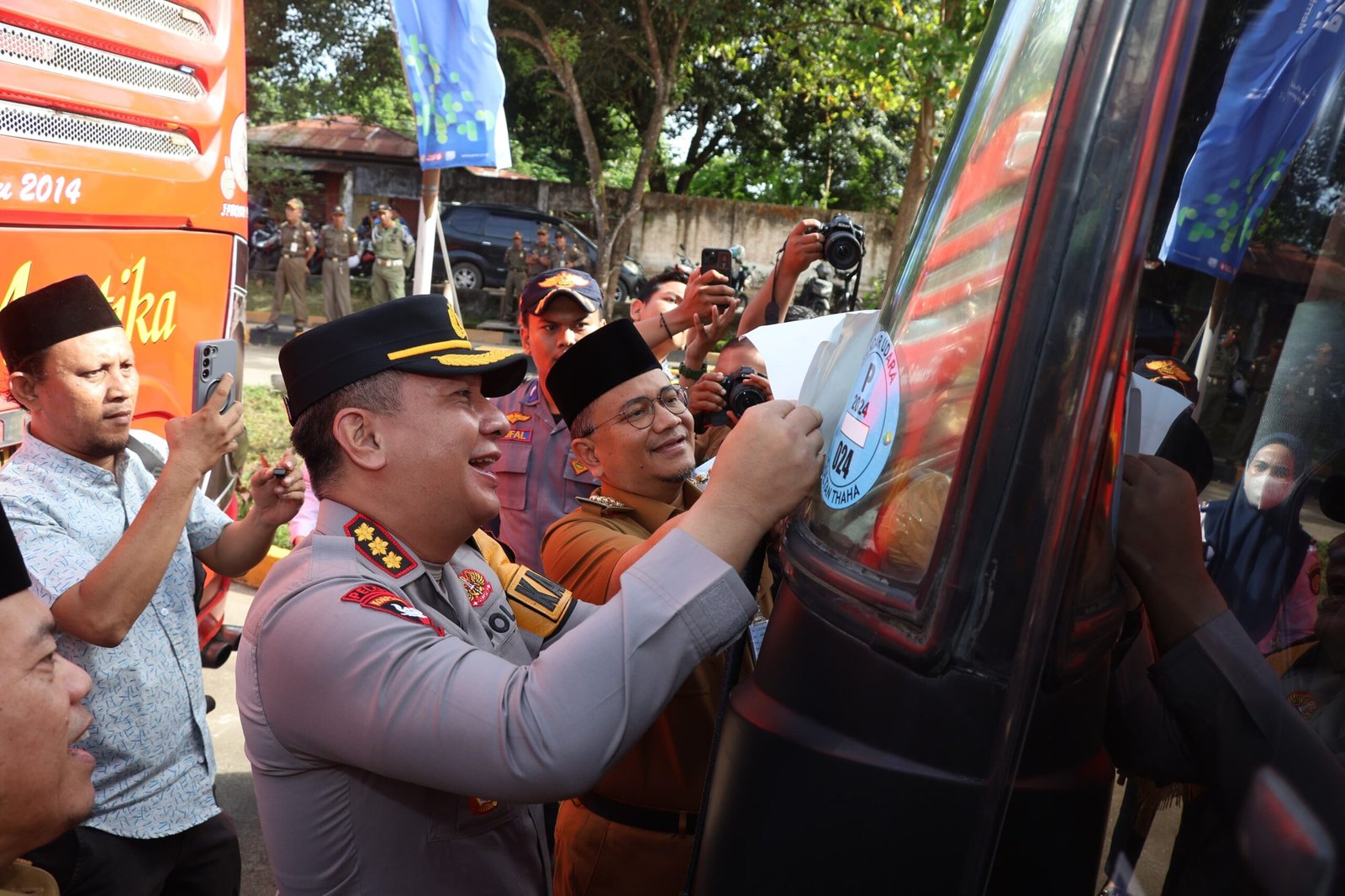 Kapolresta Jambi memasang stiker mudik lebaran gratis di bus pengangkut penumpang